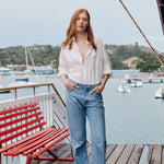Woman wearing white cotton button-up shirt in relaxed casual style