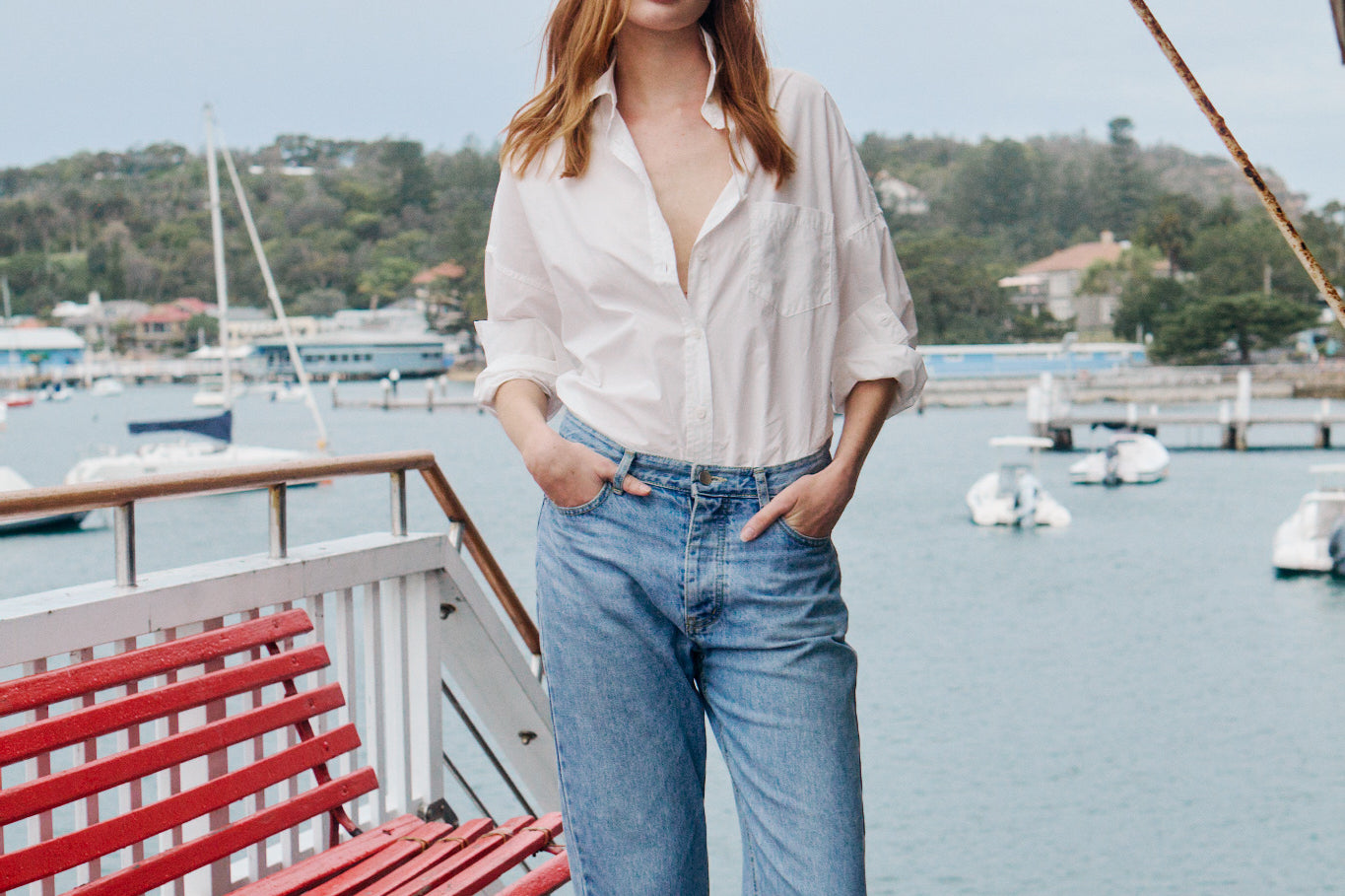 Woman wearing white cotton button-up shirt in relaxed casual style