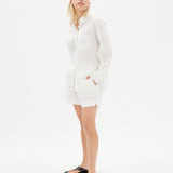 Classic white cotton shirt styled casually, showing versatile everyday wea