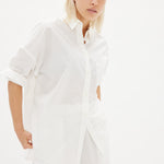 Classic white cotton shirt styled casually, showing versatile everyday wear
