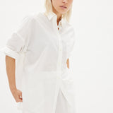 Classic white cotton shirt styled casually, showing versatile everyday wear