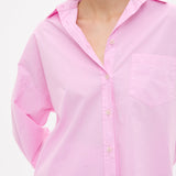 Woman wearing rose glow oversized cotton button-up shirt with chest pocket and drop shoulders