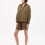 Dark olive Classic Long Sleeve Shirt with button-up front, chest pocket, drop shoulders, and relaxed fit made from 100% yarn-dyed cotton.