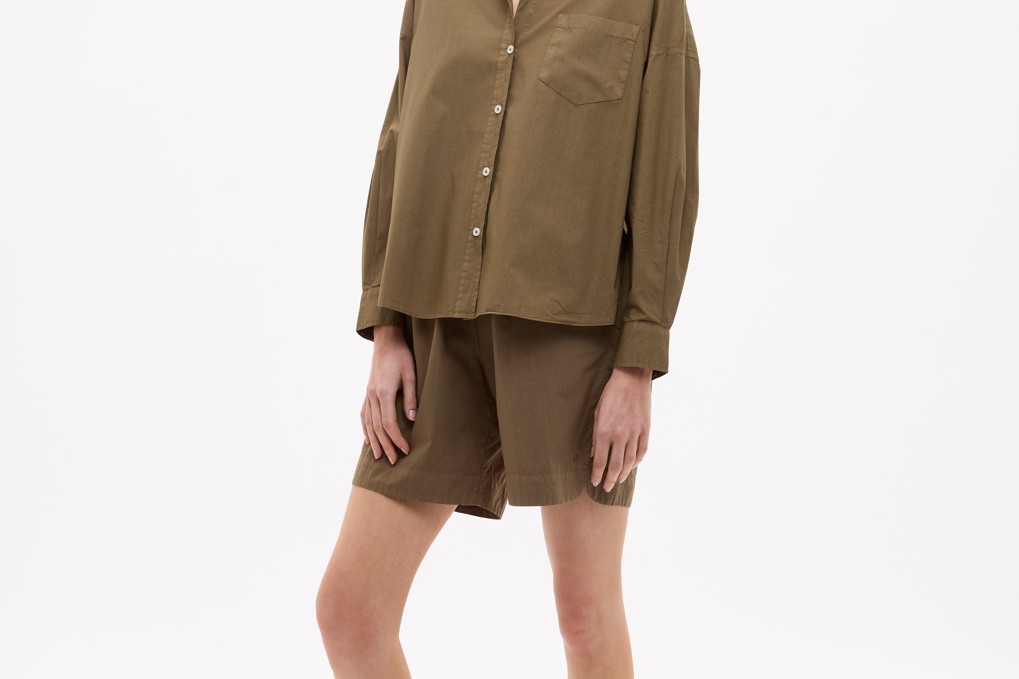 Dark olive Classic Long Sleeve Shirt with button-up front, chest pocket, drop shoulders, and relaxed fit made from 100% yarn-dyed cotton.