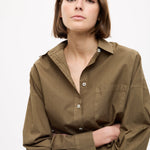 Dark olive Classic Long Sleeve Shirt with custom stripe, chest pocket, drop shoulders, and relaxed fit made from 100% cotton.