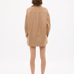 Woman seen from behind wearing a Mara Oversized Long Sleeve Shirt - Toffee with relaxed fit and long cuffs