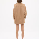 Woman seen from behind wearing a Mara Oversized Long Sleeve Shirt - Toffee with relaxed fit and long cuffs