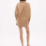 Woman wearing Mara Oversized Long Sleeve Shirt - Toffee in a relaxed fit, shown from behind on a white background.
