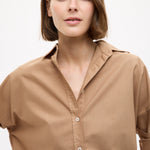 Woman wearing a Mara Oversized Long Sleeve Shirt - Toffee with rolled sleeves and a relaxed collar style.