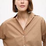 Woman wearing a Mara Oversized Long Sleeve Shirt - Toffee with rolled sleeves and a relaxed collar style.