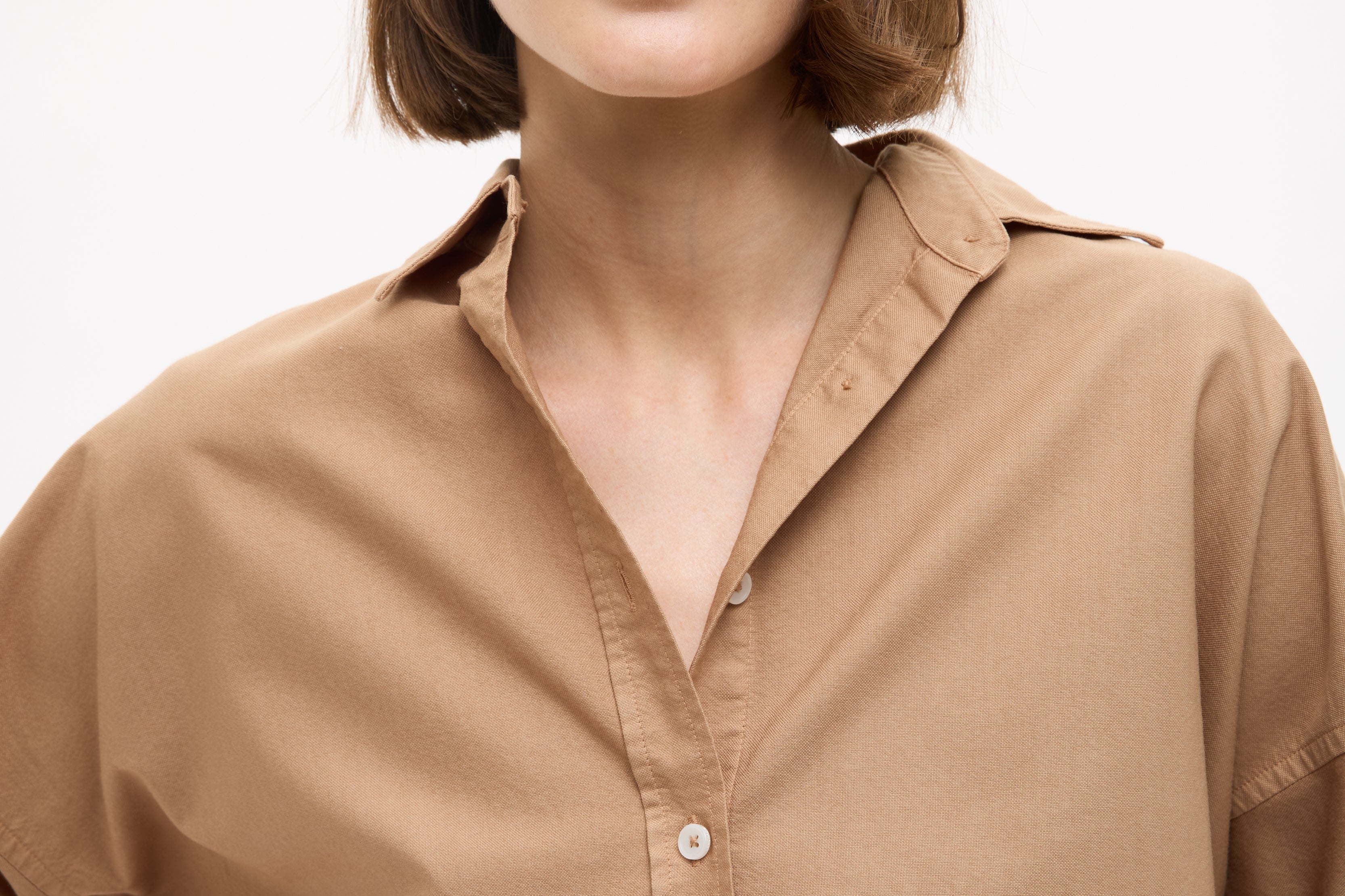 Woman wearing a Mara Oversized Long Sleeve Shirt - Toffee with rolled sleeves and a relaxed collar style.
