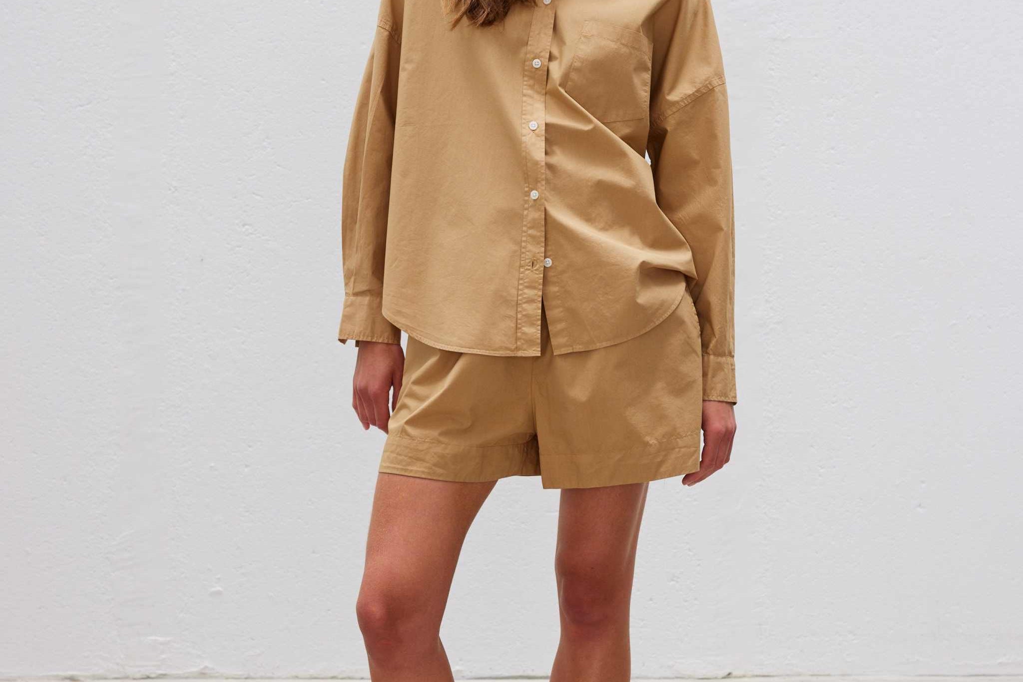 Woman wearing Chiara Long Sleeve Shirt in toffee color with matching shorts.