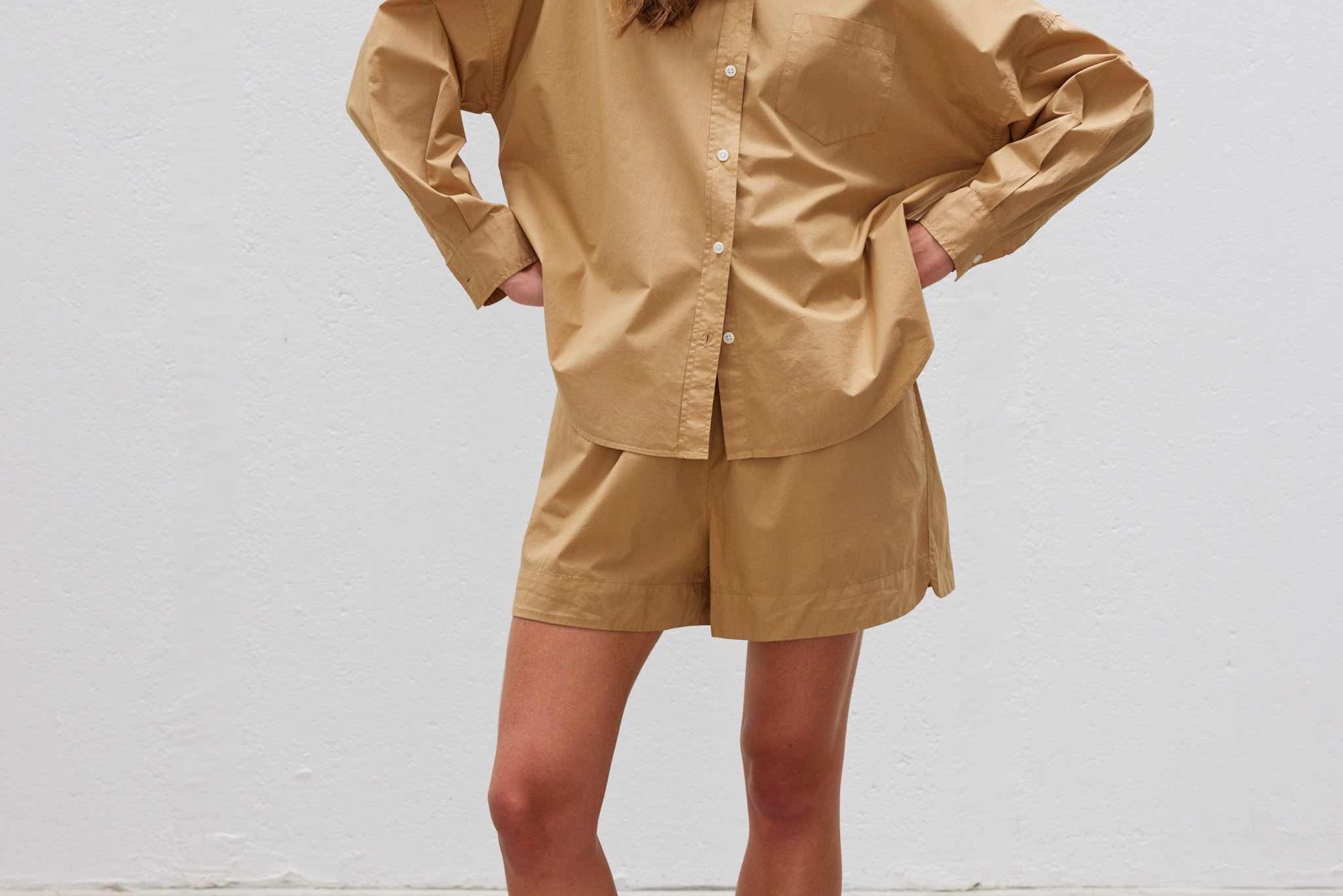Woman wearing toffee Chiara Long Sleeve Shirt and matching shorts with relaxed fit and button-up front