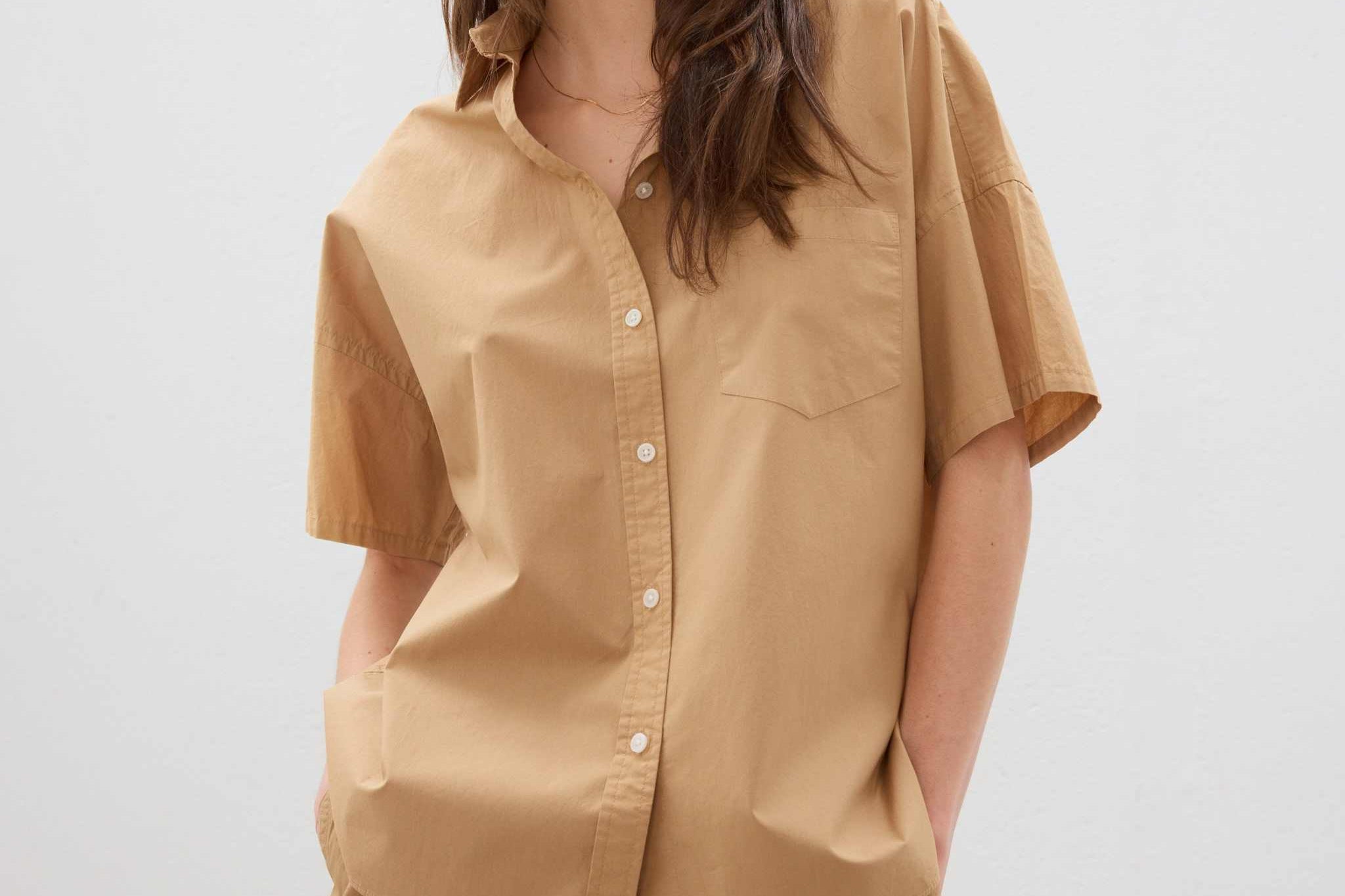 Woman wearing toffee color cotton button-up short sleeve shirt with matching shorts in relaxed fit
